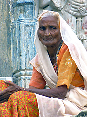 Rajasthani woman sitting in stairs of temple